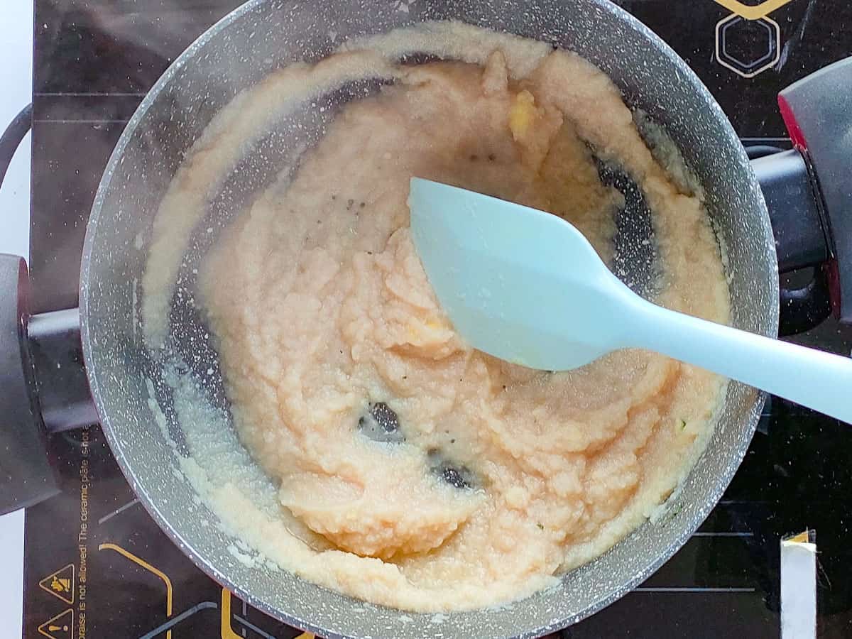 Blended onions being sauteed in a cooking pot.