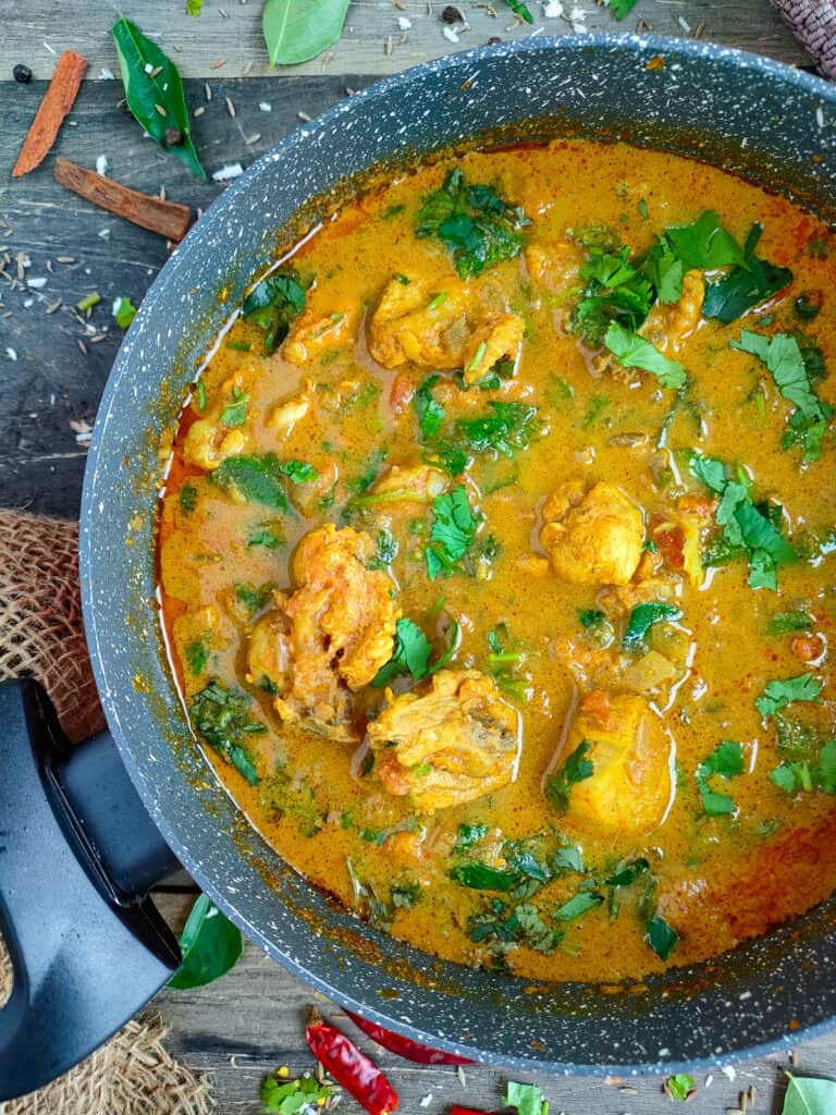 Varutharacha chicken curry in a non-stick cooking pot.