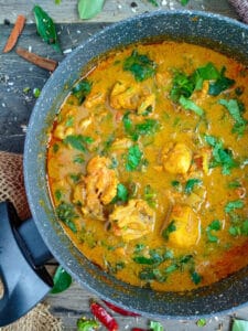 Varutharacha chicken curry in a non-stick cooking pot.