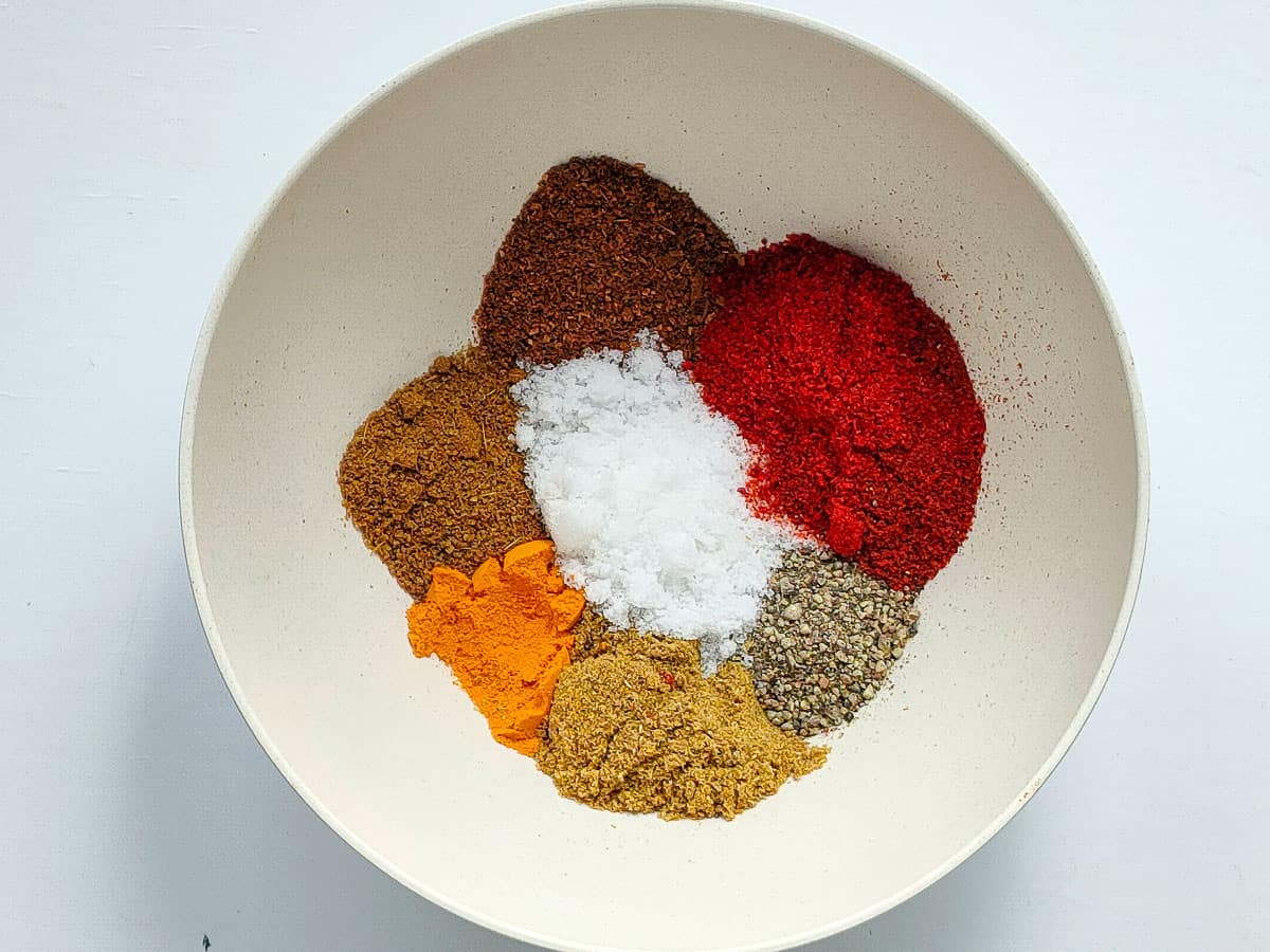 Spices for egg keema recipe in a small white bowl.