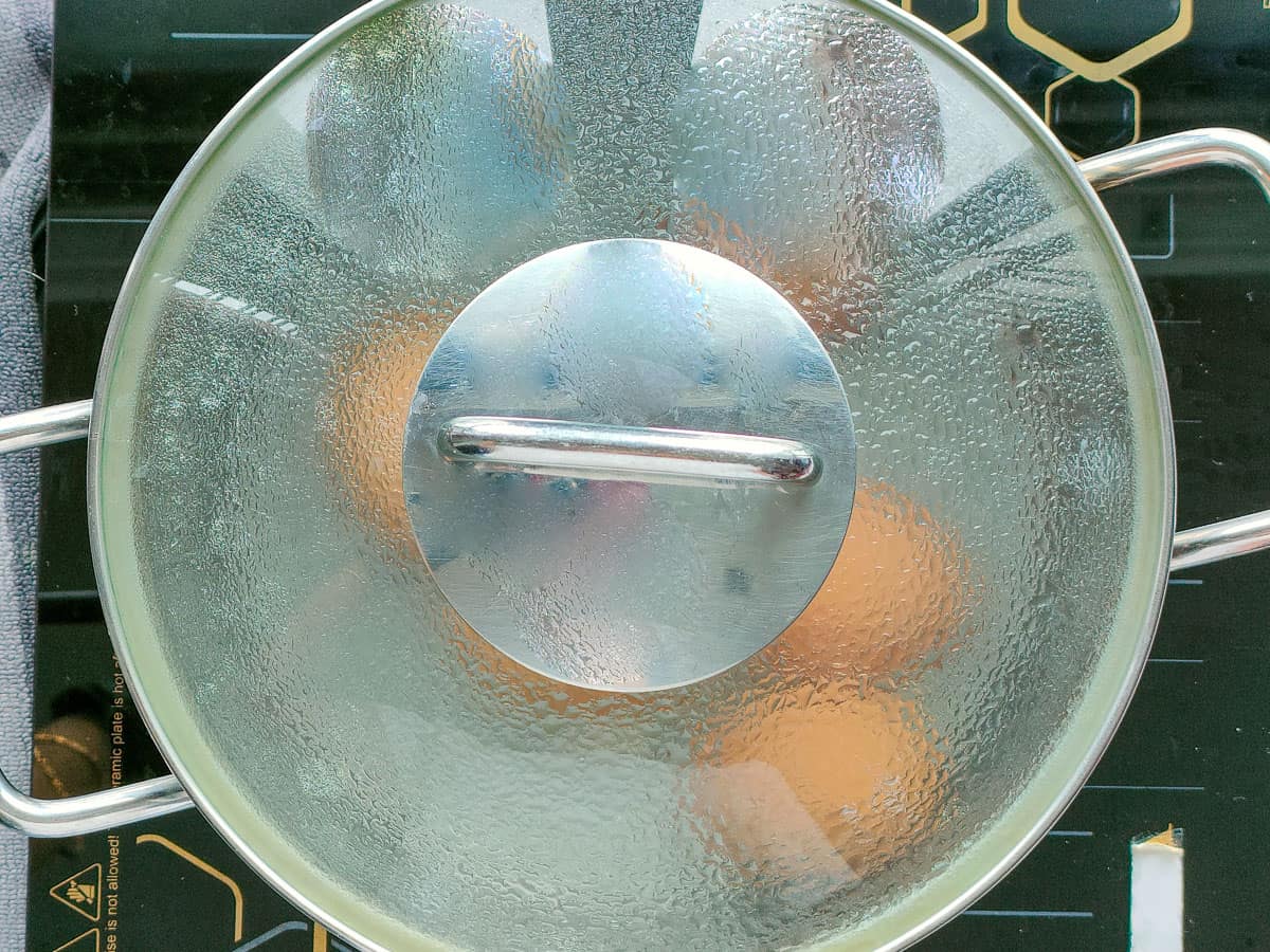 Boiled eggs in a covered pot.