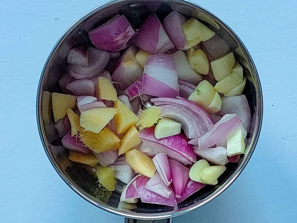 Onions, ginger and garlic in a blender jar.