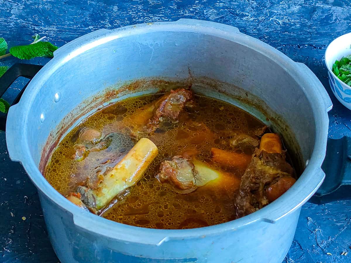 Cooked mutton soup in a pressure cooker.