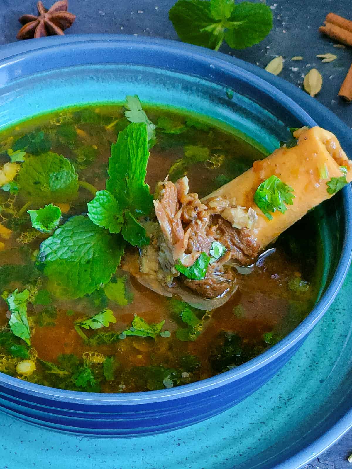 Mutton bone soup in a blue bowl.