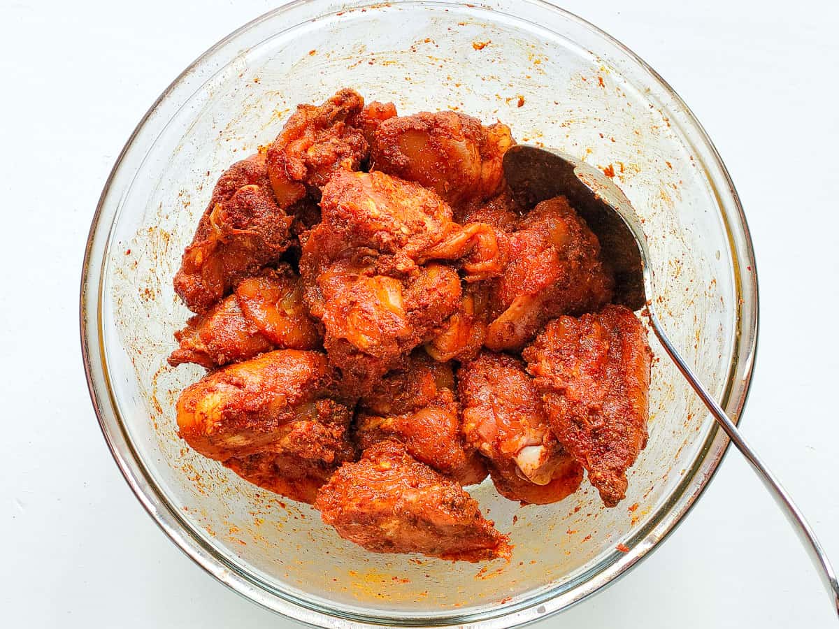 Marinated chicken in a glass bowl.