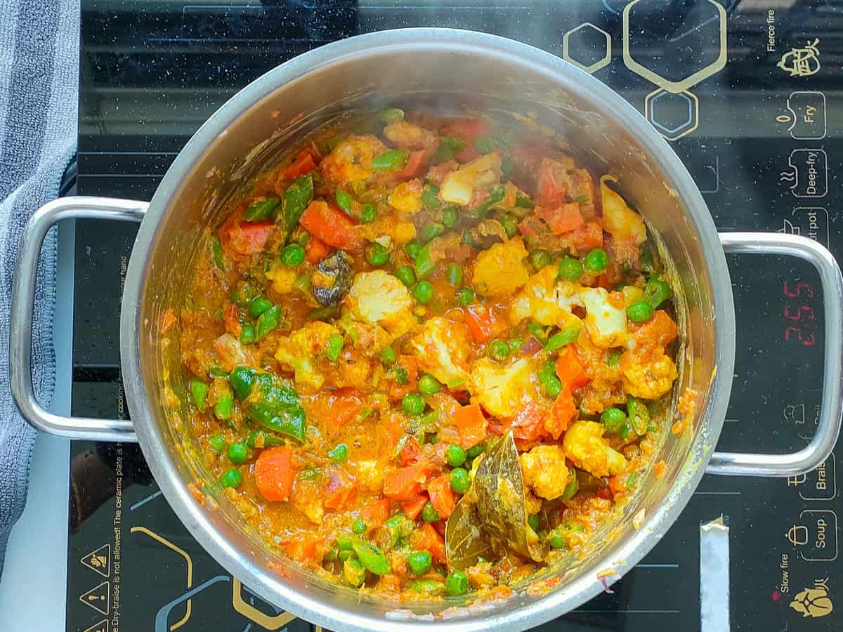 Sauteed vegetables in a large pot.