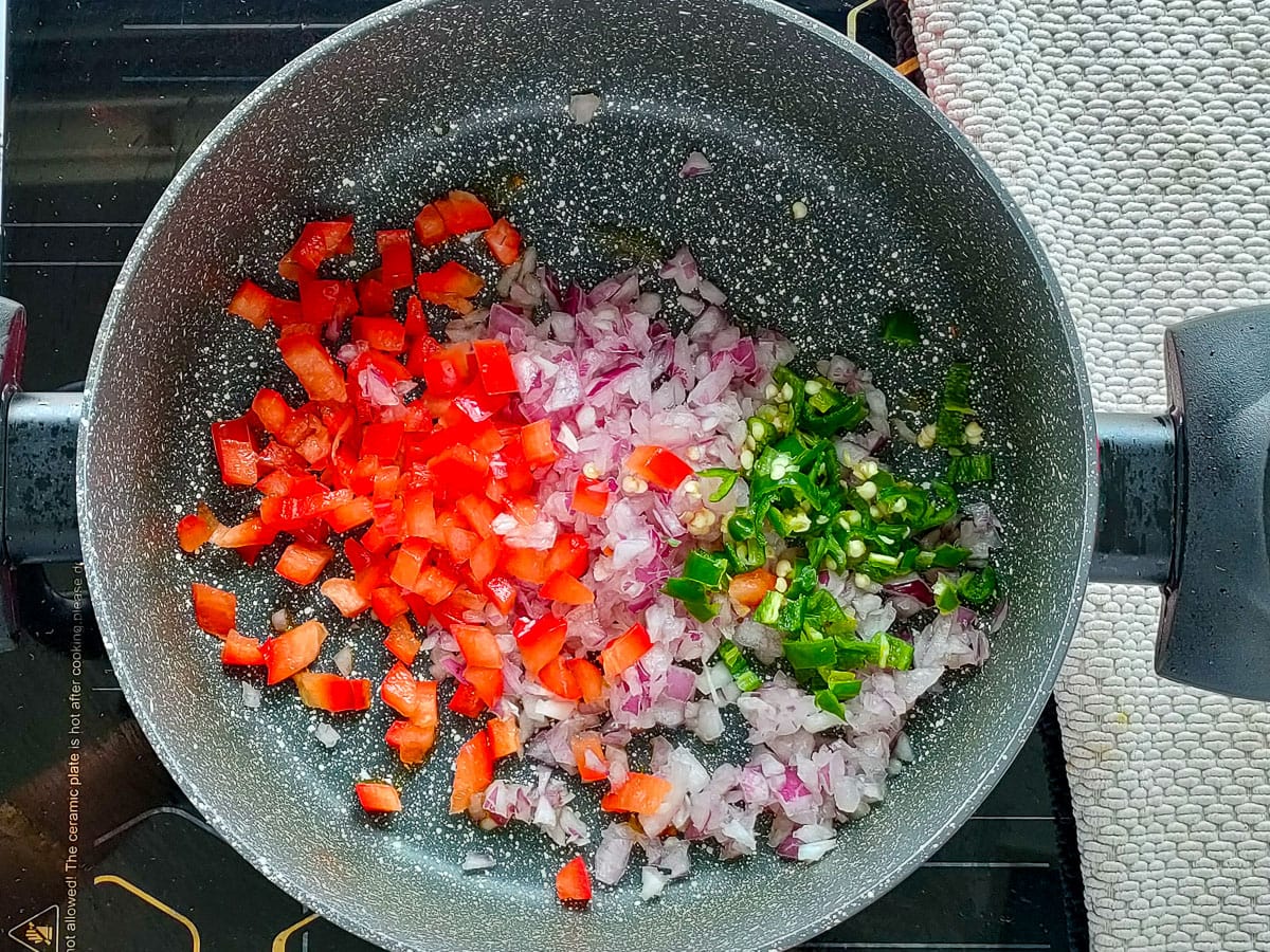 Sauteed vegetables in a large pot.