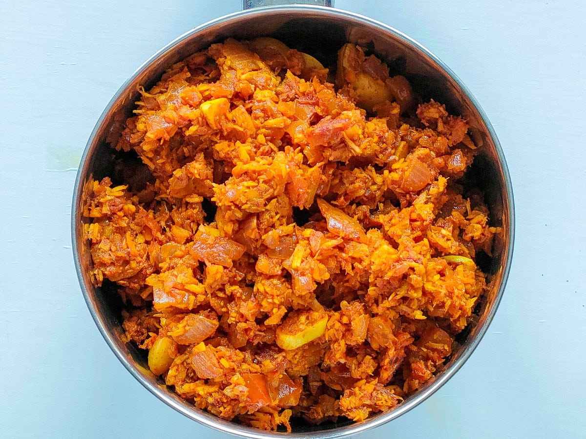 Roasted coconut and spices in a blender jar.