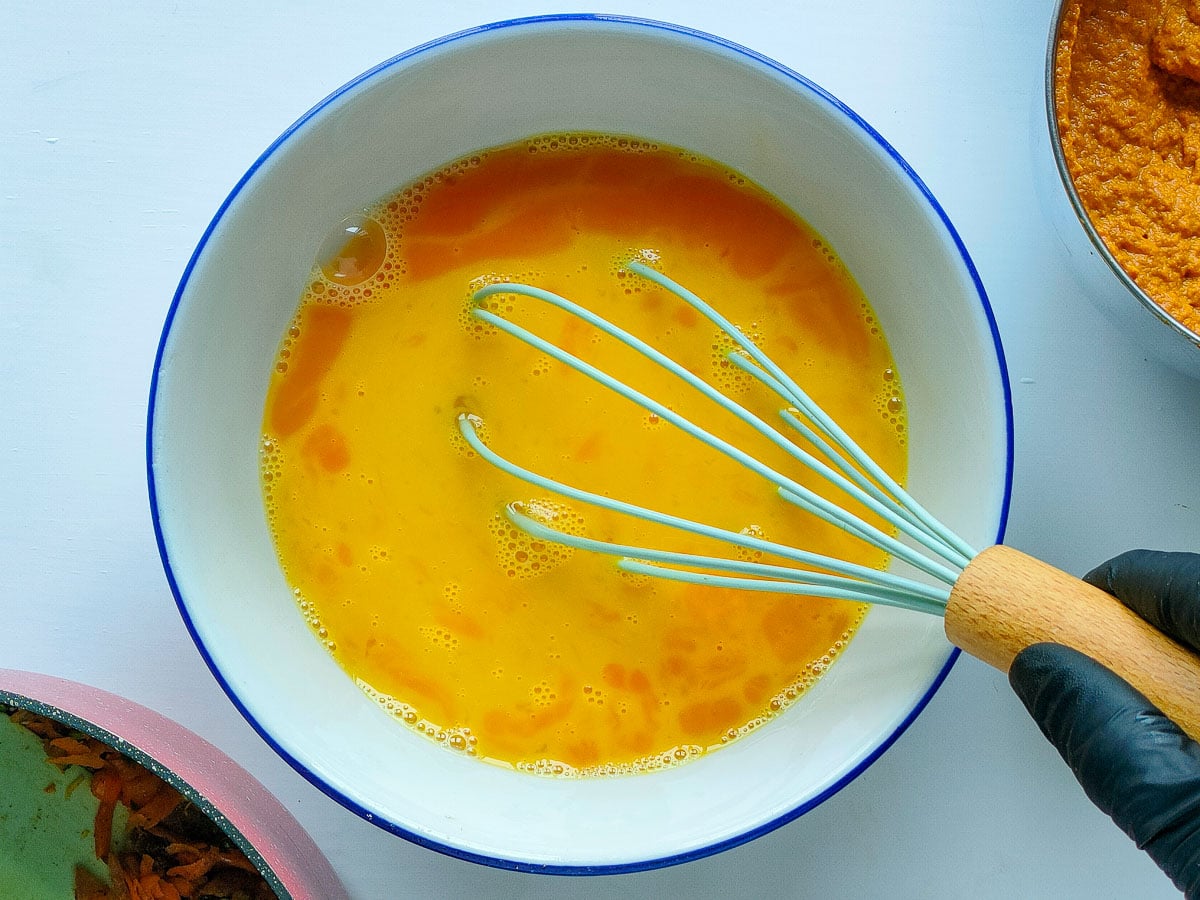 Beaten eggs in a bowl.