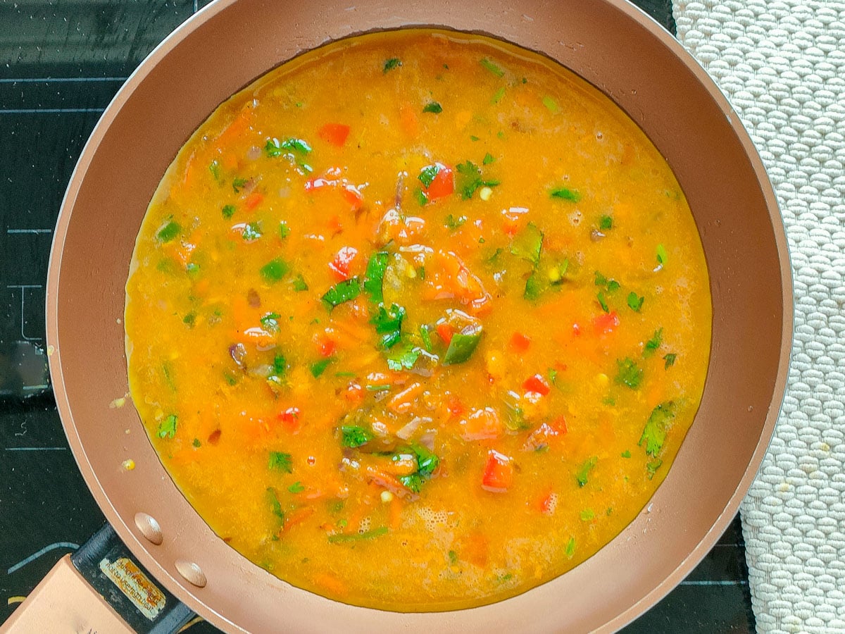 Egg mixture being cooked in an omelet pan.