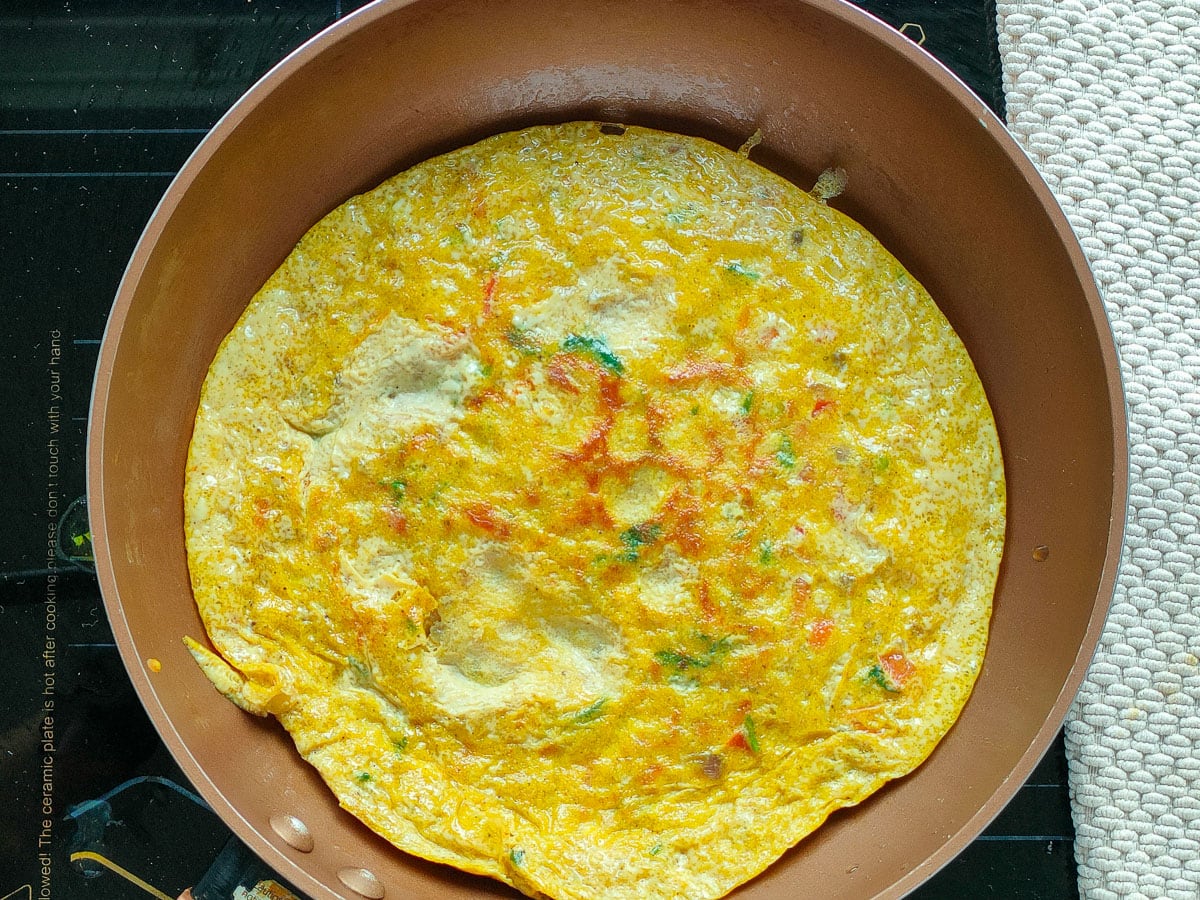 Flipped omelet in a frying pan.