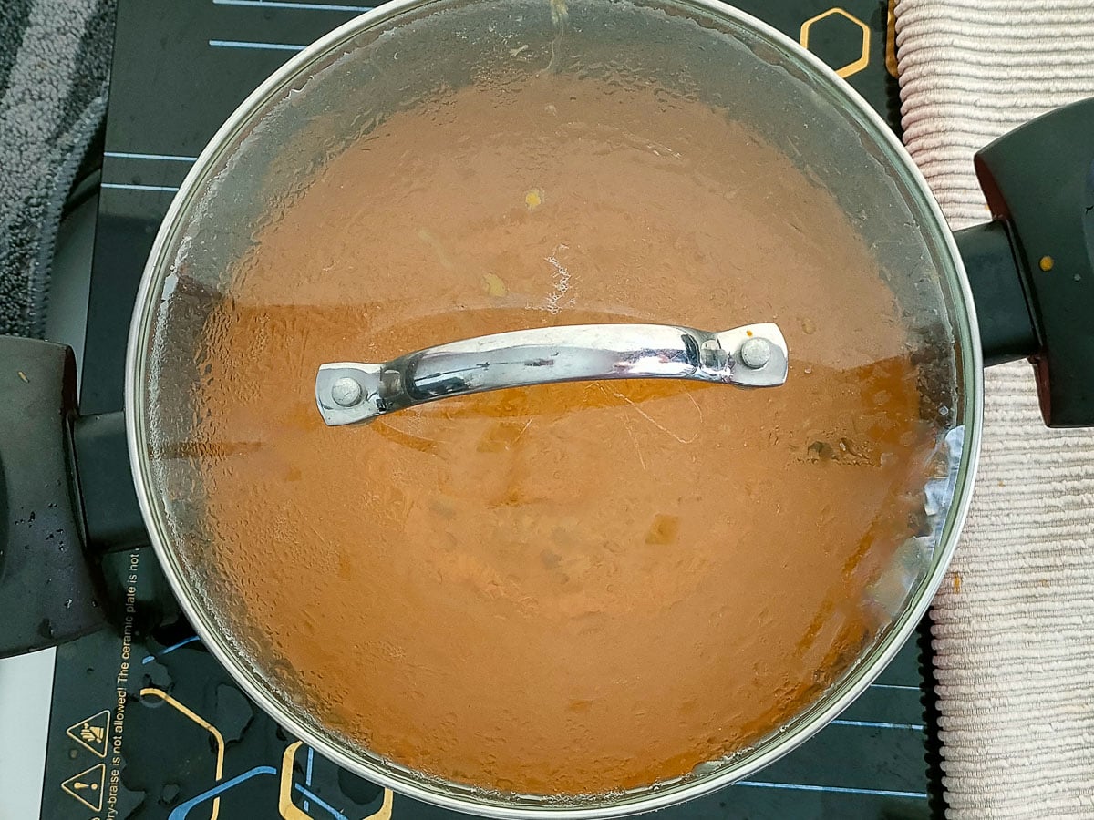 Omelet curry simmering in a covered pot.