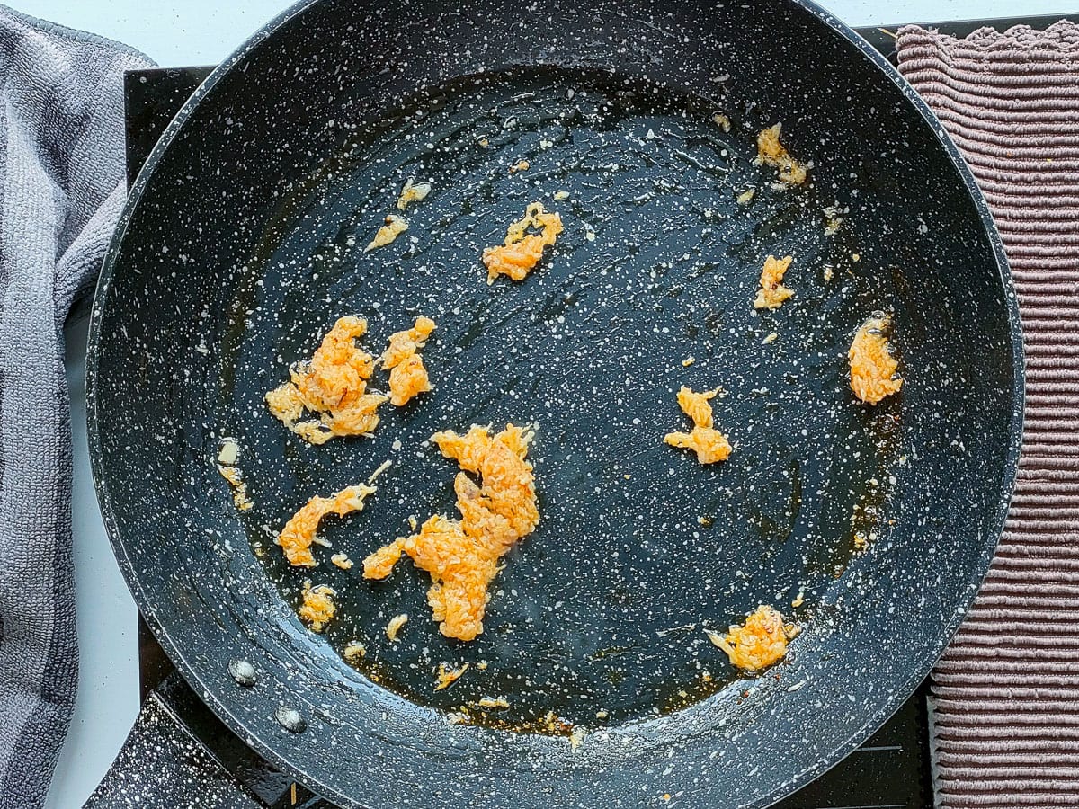 Minced sauteed garlic in a frying pan.