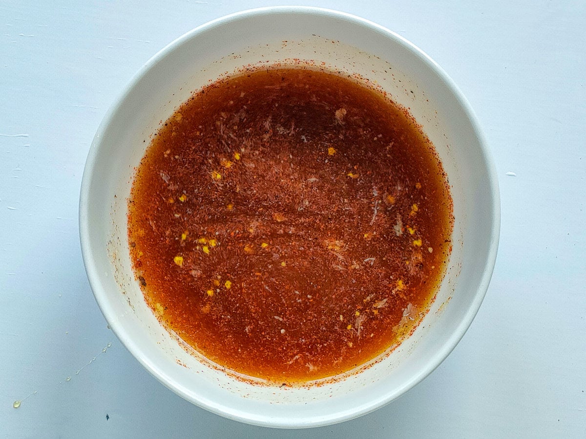 Honey lemon pepper sauce mixture in a small bowl.