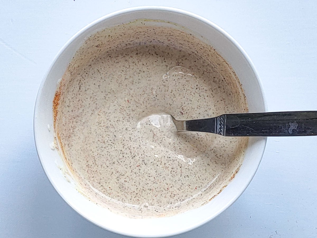 Yogurt dressing for potato salad in a small bowl.