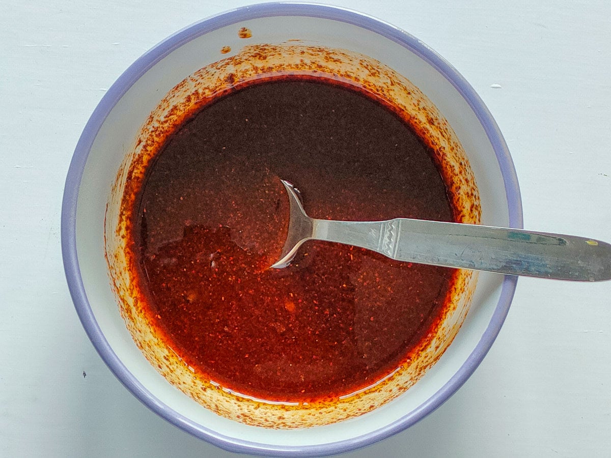 Balsamic seasoning for brussels sprouts and carrots in a small bowl.