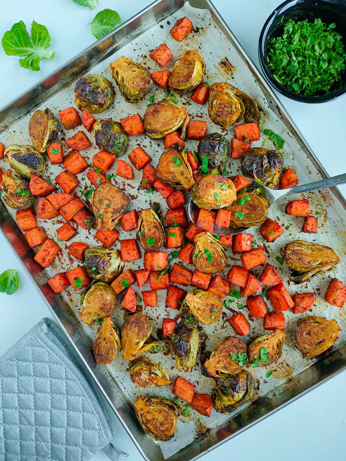 Balsamic roasted carrots and brussels sprouts on a sheet pan.