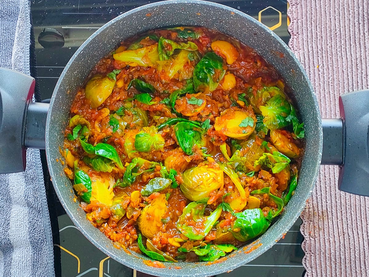 Curried Brussels sprouts in a pot.