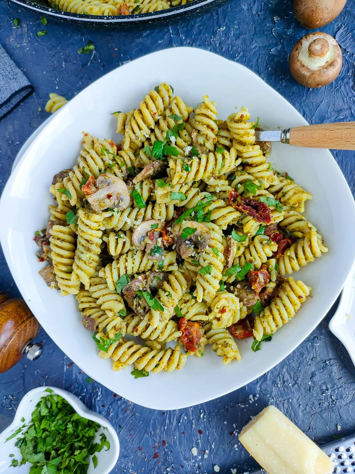 Mushroom pesto pasta on a white plate.