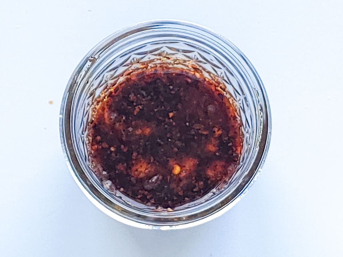 Asian sesame dressing ingredients in a glass jar.