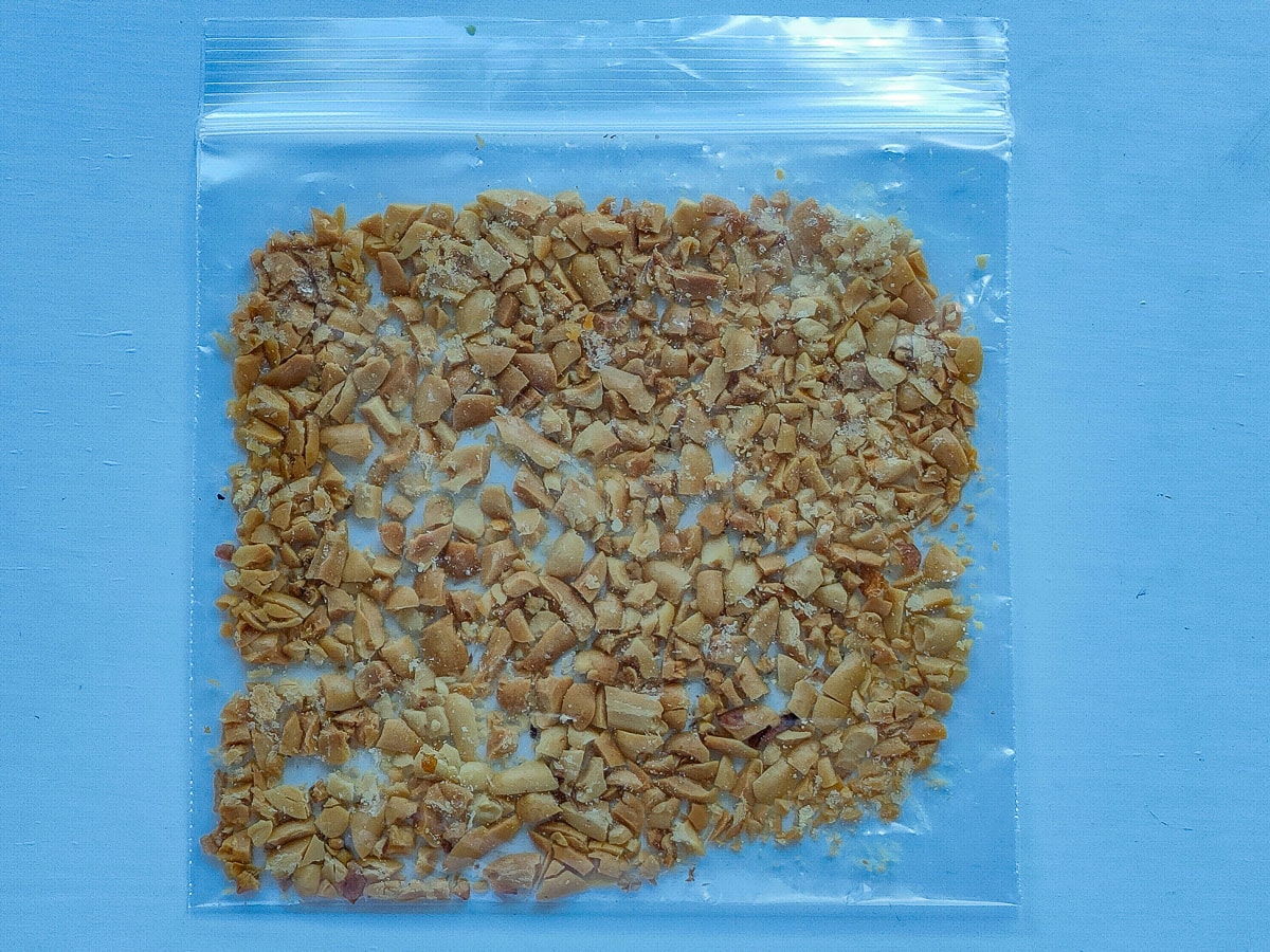 Roasted and roughly crushed peanuts in a zip lock bag.