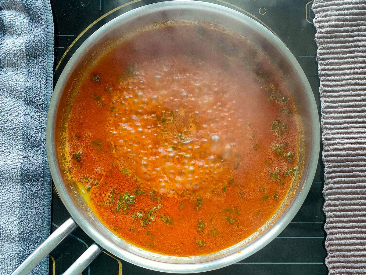 Brussels sprouts marinade simmering in a small pan.