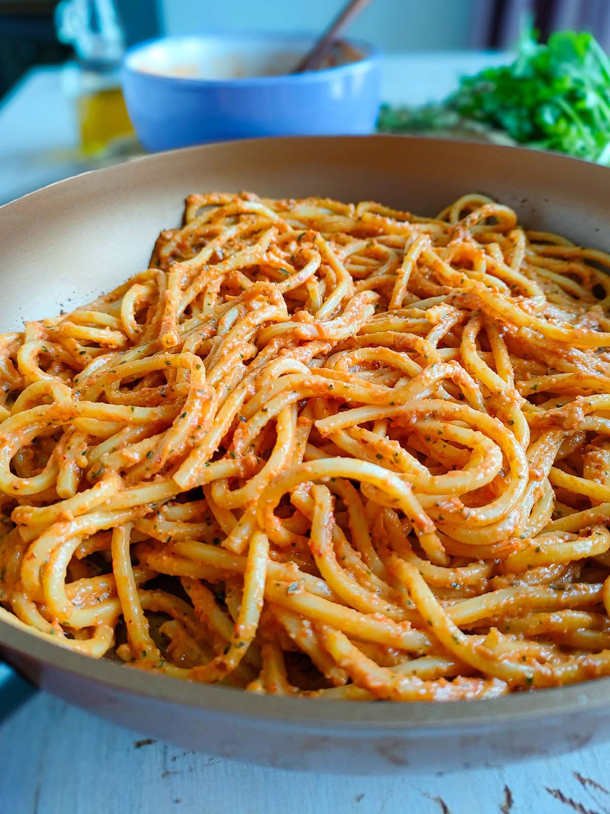 Red pepper pesto pasta in a pan.