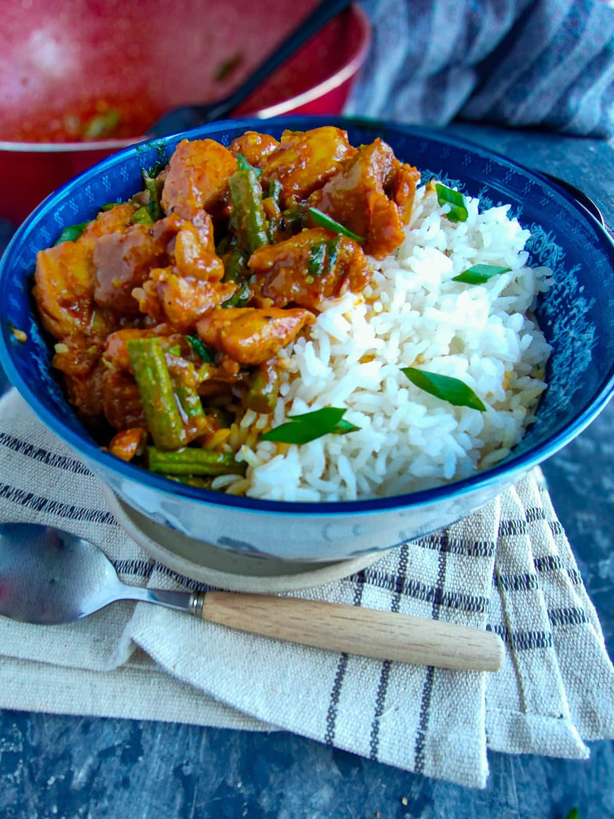 Easy Weeknight Chicken and String Bean Stir fry String bean chicken served in a blue bowl with rice.
