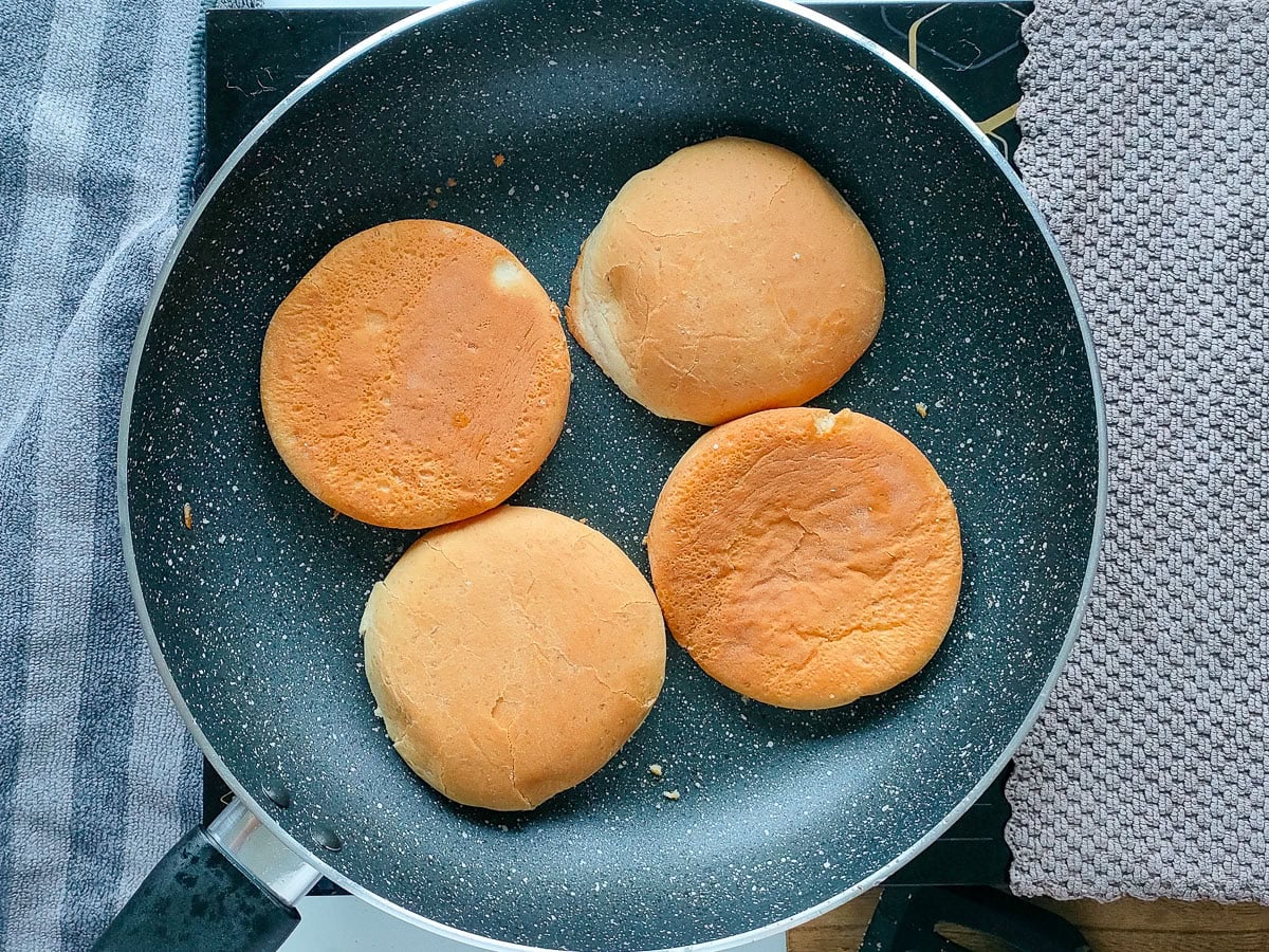 Wholesome Chipotle Chicken Sandwich with Easy Avocado Spread Sandwich buns being toasted on a pan.