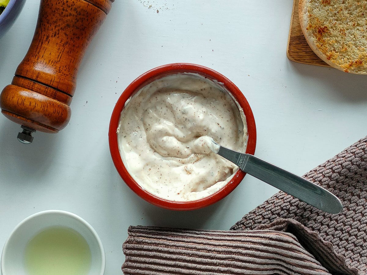 Wholesome Chipotle Chicken Sandwich with Easy Avocado Spread Chipotle lime sauce with yogurt in a brown bowl.