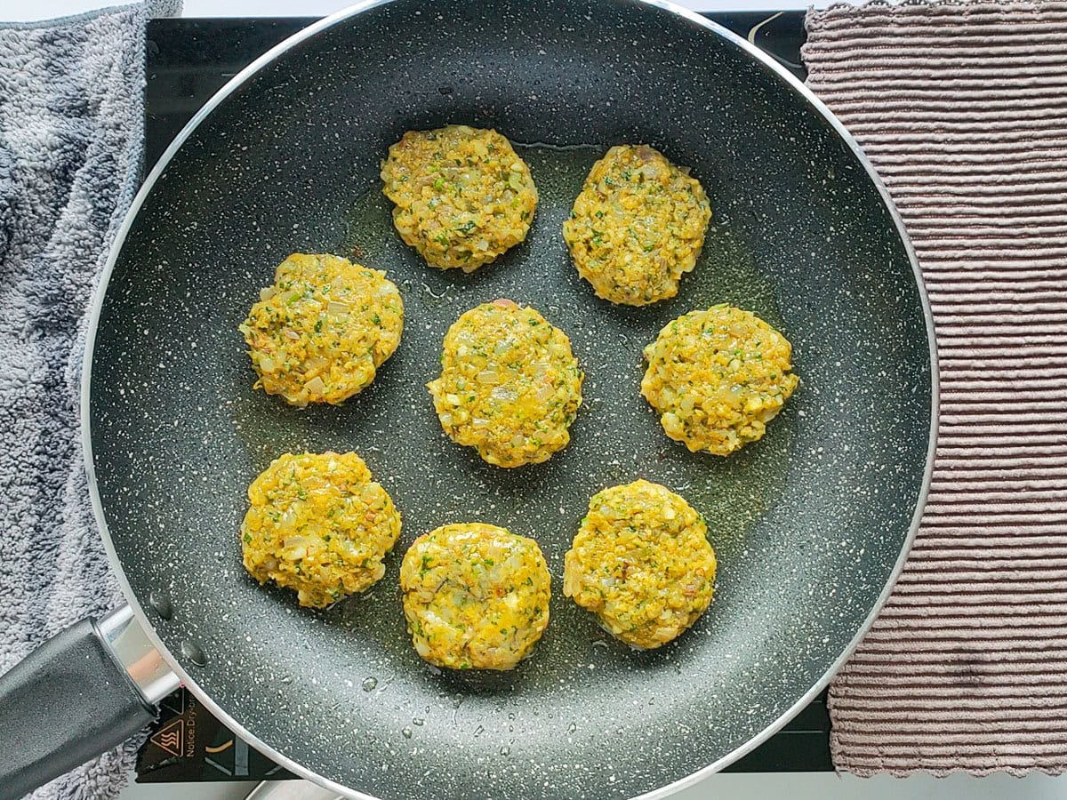 Easy Shrimp Fritters | Prawn Cutlets (no deep frying) Prawn cutlets being fried on a non-stick pan.