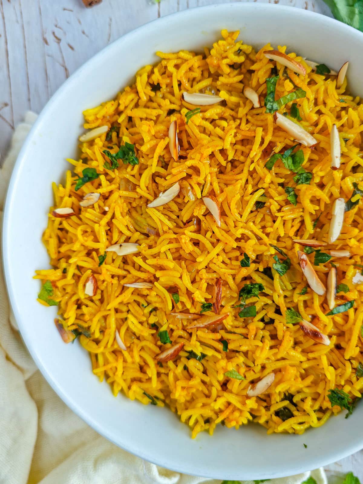 Mediterranean saffron rice in a large white bowl.