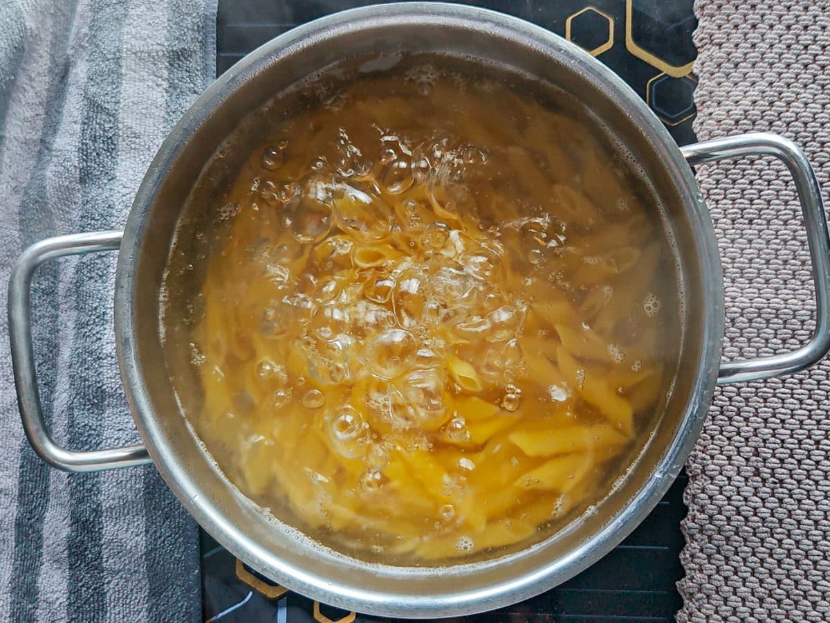 Cajun Pasta with Salmon (without cream) Pasta boiling in a large pot.