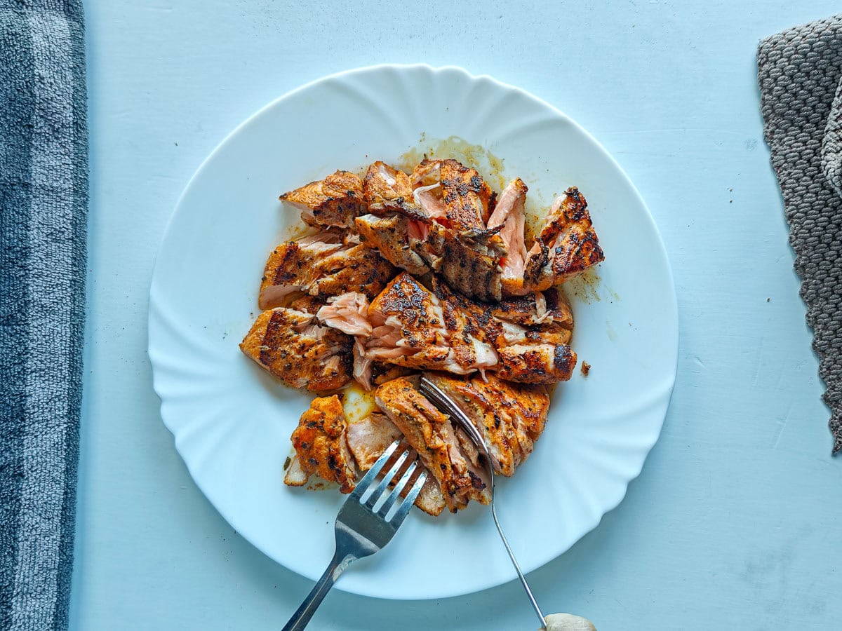 Cajun Pasta with Salmon (without cream) Shredded Cajun salmon on a plate.