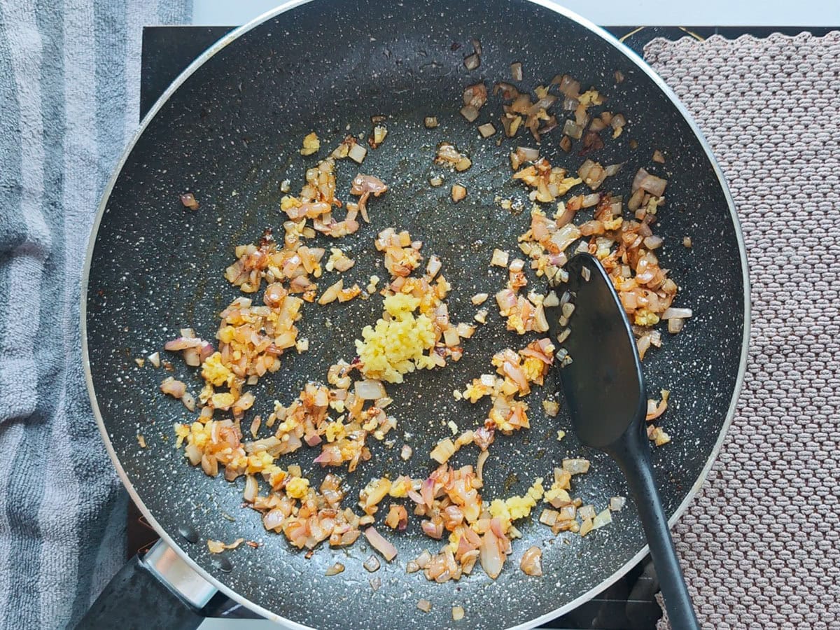 Cajun Pasta with Salmon (without cream) Sauteed onions with garlic in a pan.