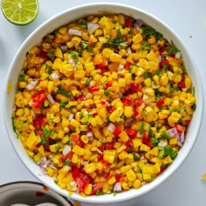 Easy Corn Mango Salsa Mango corn salsa in a white bowl.