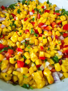 Easy Corn Mango Salsa Mango corn salsa in a white bowl.
