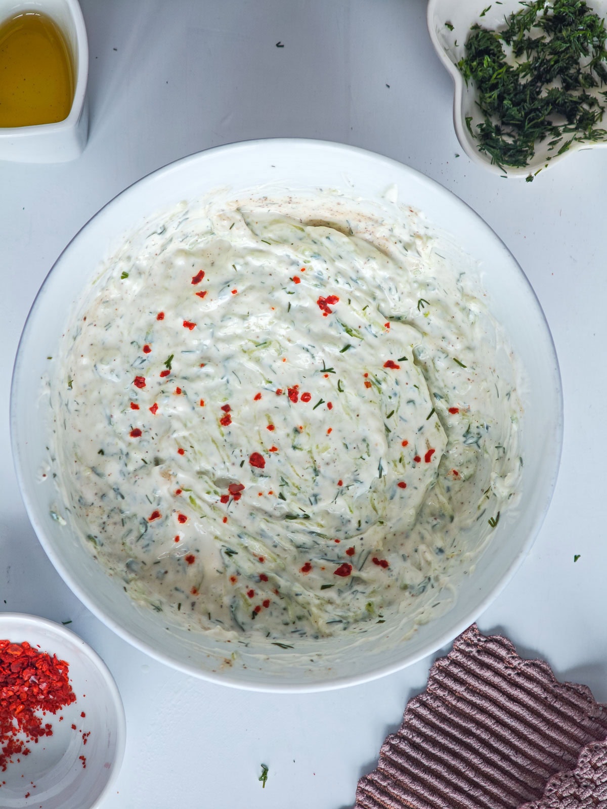 Creamy Cucumber Dill Tzatziki (Greek Yogurt Cucumber Dip) Creamy dill tzatziki in a white bowl.