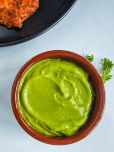 Easy Avocado Crema with Greek Yogurt Avocado crema in a brown bowl.