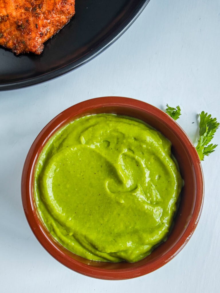 Avocado crema in a brown bowl.