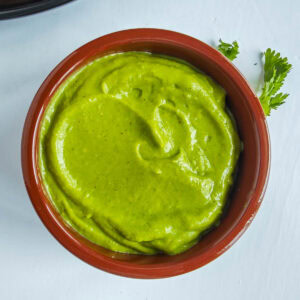 Easy Avocado Crema with Greek Yogurt Avocado crema with Greek yogurt in a brown bowl.