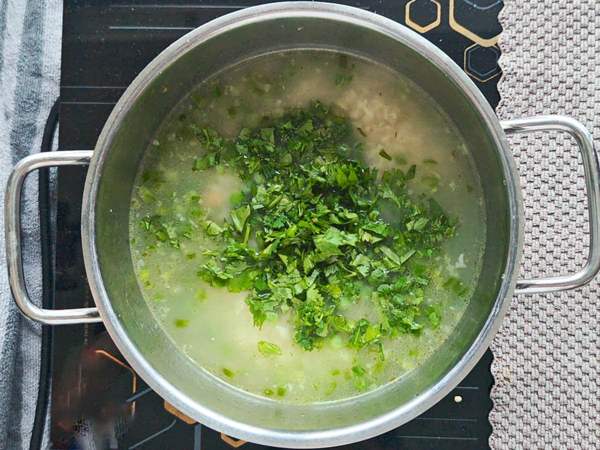 Easy One Pot Cilantro Lime Basmati Rice Basmati rice simmering with cilantro and other ingredients in a deep pot.