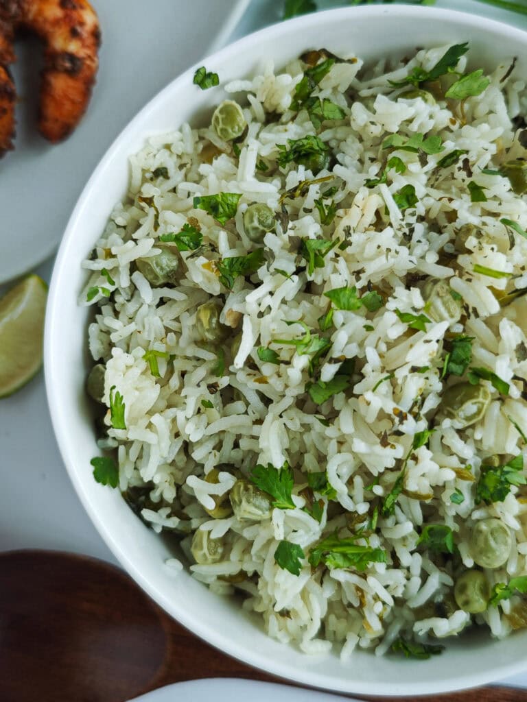 Basmati rice with lime and cilantro in a white bowl.