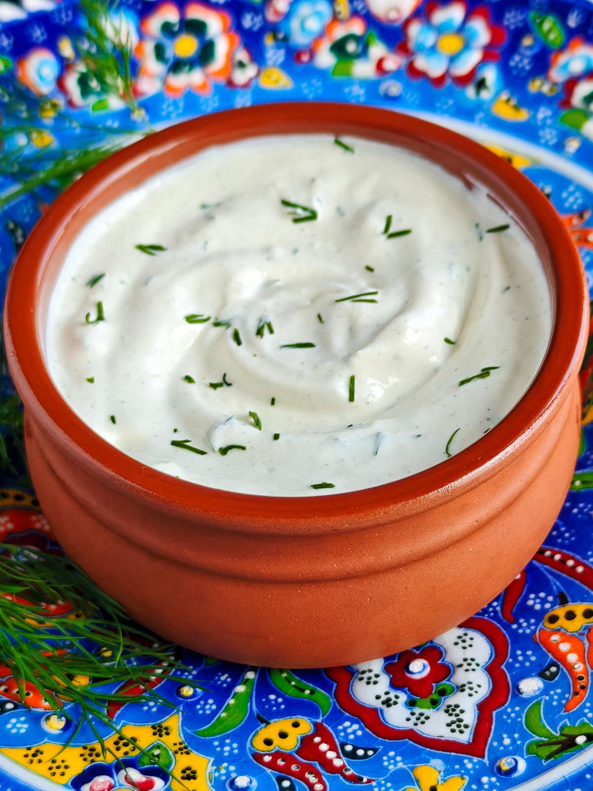 Easy Garlic Yogurt Sauce (with Roasted Garlic) Greek yogurt garlic sauce with dill in a bowl.