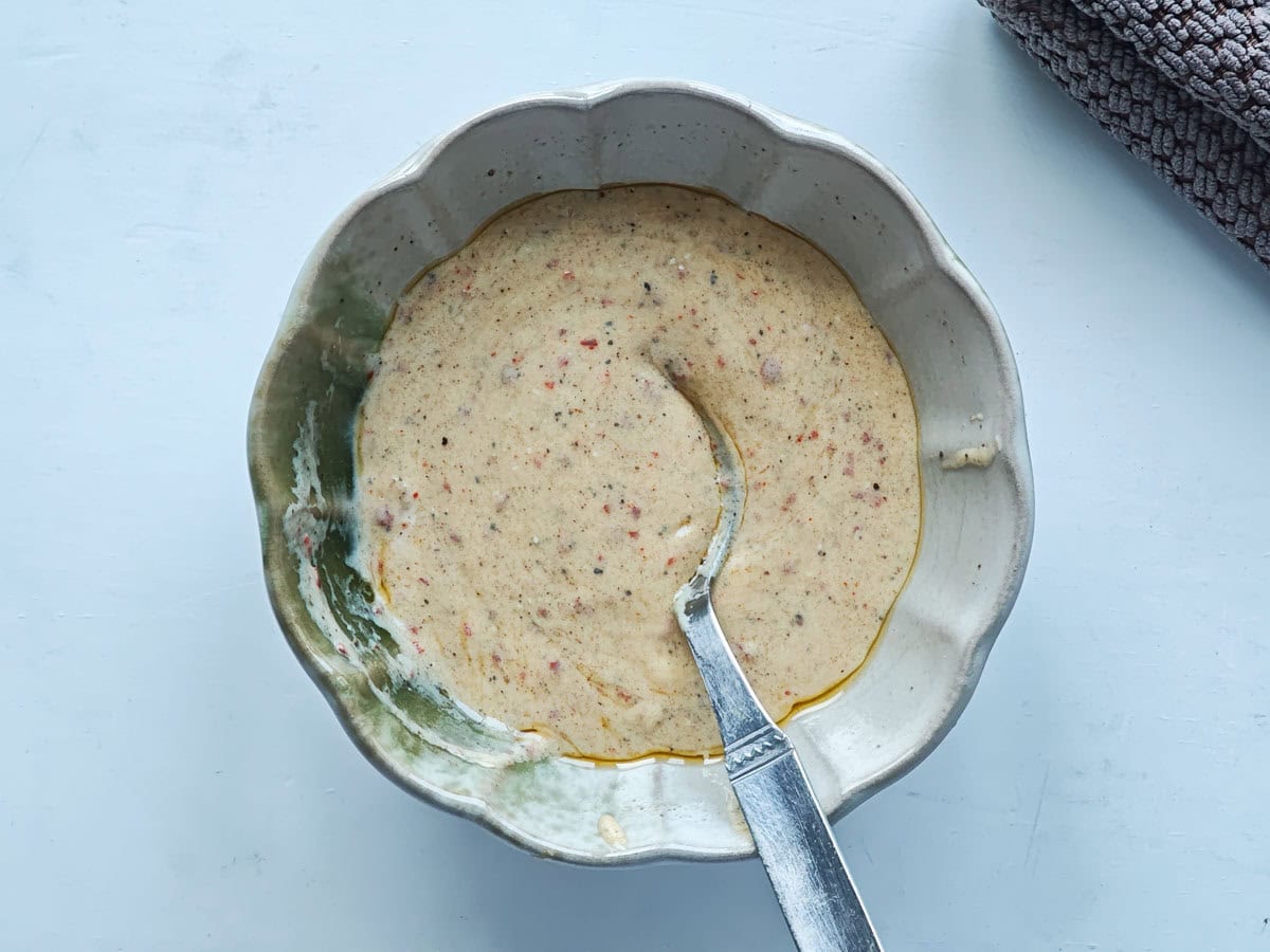 Mediterranean Chickpea Tuna Salad (No Mayo, High Protein) Creamy Dijon yogurt dressing in a small bowl.
