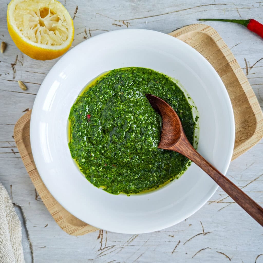 Easy Chimichurri Rice with Vegetables Chimichurri with basil in a deep plate with a spoon in it.