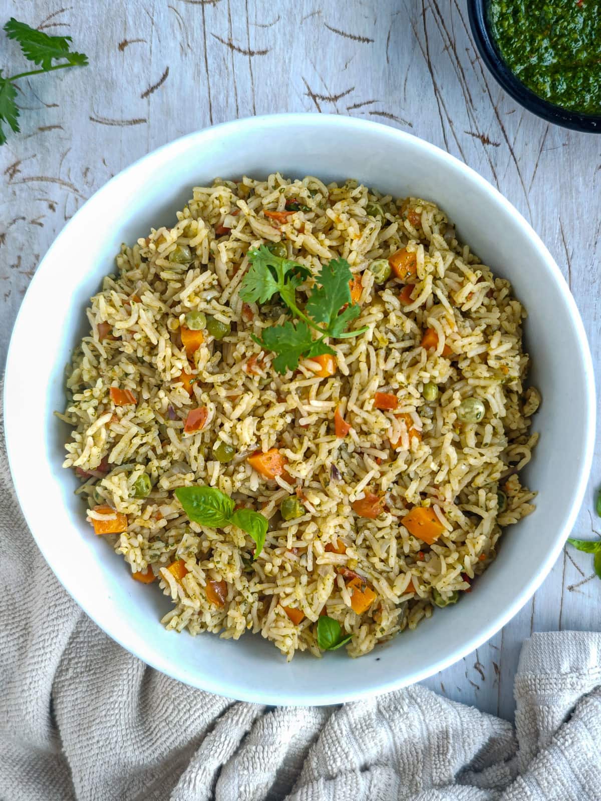 Easy Chimichurri Rice with Vegetables Rice with chimichurri sauce in a white bowl.