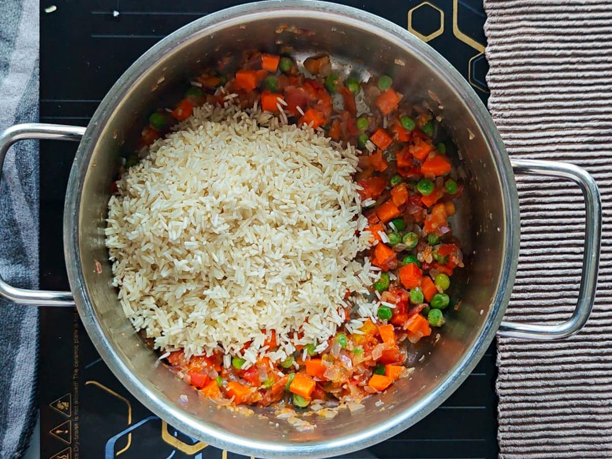 Easy Chimichurri Rice with Vegetables Basmati rice with sauteed vegetables in a pot.