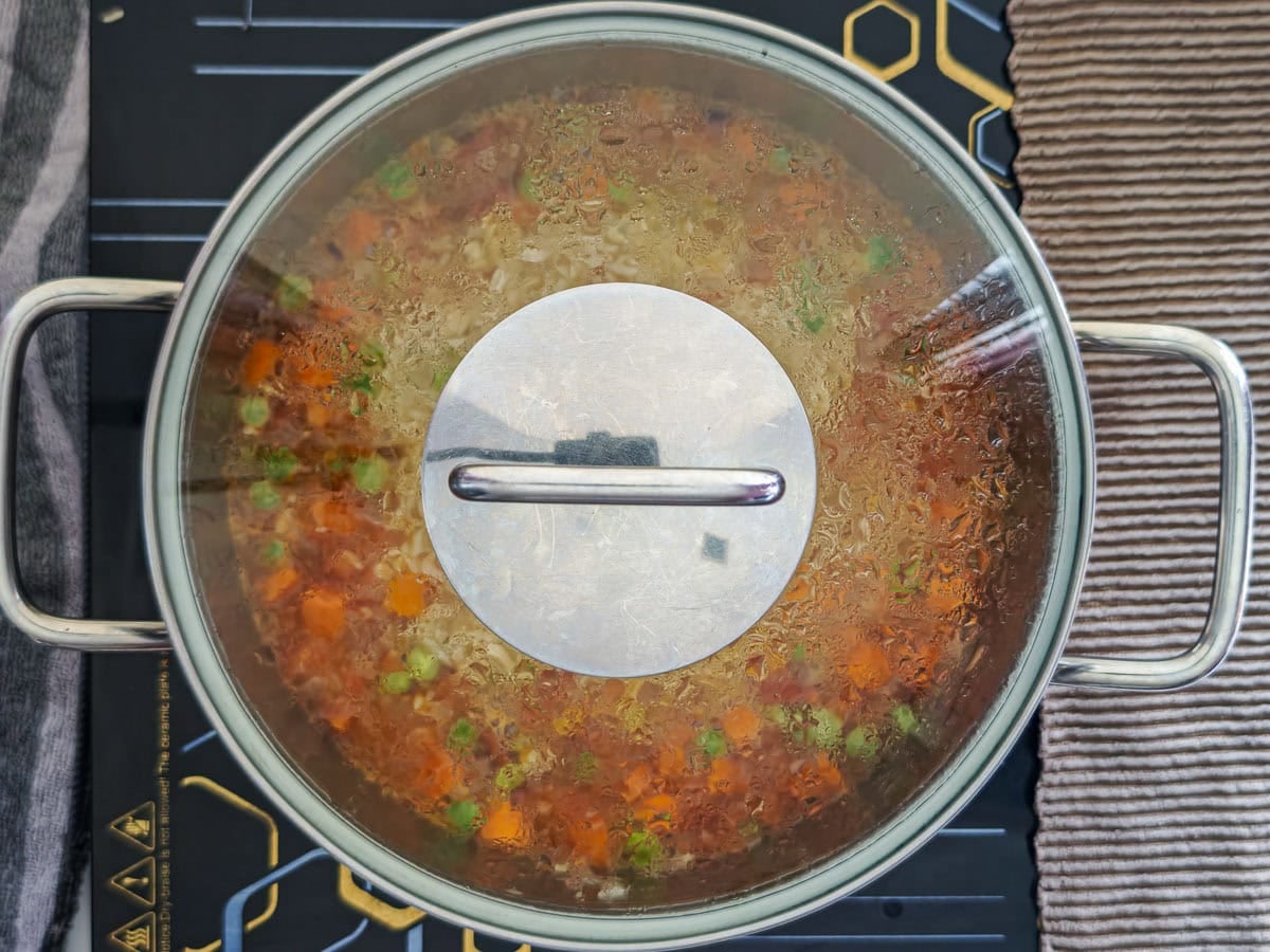 Easy Chimichurri Rice with Vegetables Basmati rice with veggies cooking in a closed pot.
