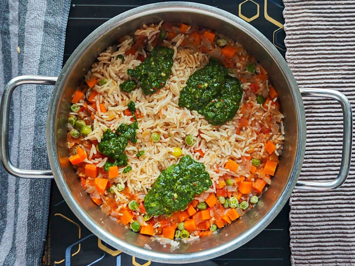 Easy Chimichurri Rice with Vegetables Basil chimichurri added to cooked rice and vegetables in a pot.